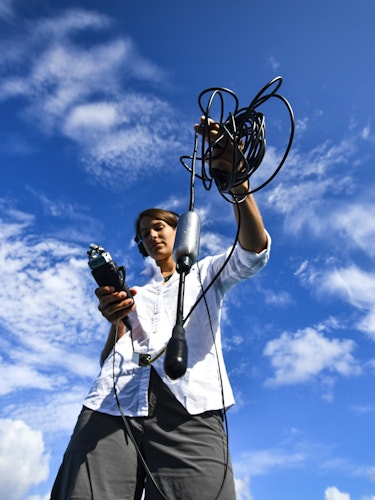 Woman holding a hydrophone